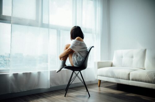 Woman sitting on chair alone